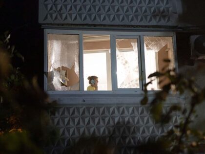 KHARKIV, UKRAINE - JUNE 5: A woman talks on the phone on the balcony of a damaged resident