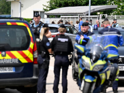 Students leave as French gendarmes control the access to a secondary school after a 31-yea