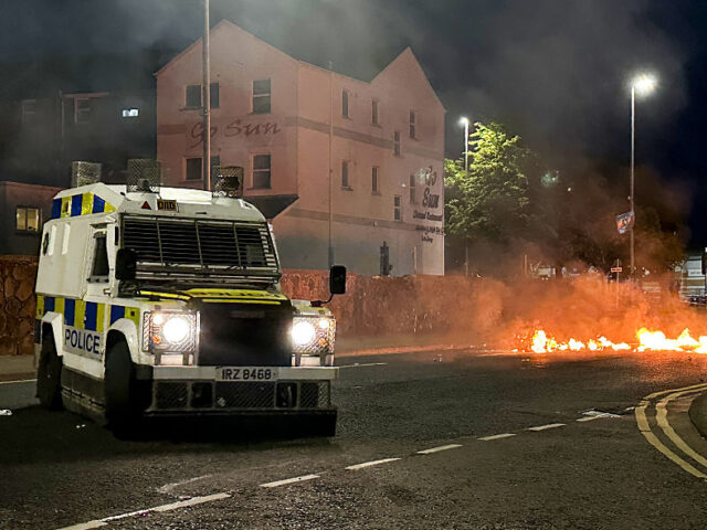 Ballymena Protest A PSNI vehicle near to debris on fire during a third night of disorder in Ballymena, Co An