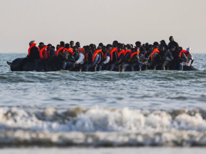 Migrants aboard a smuggler's boat attempt to cross the English Channel off the beach of Gr