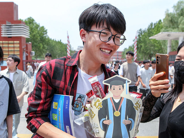 GettyImages-2219283900 JIAOZUO, CHINA - JUNE 09: A gaokao candidate receives gifts from his families outside an e