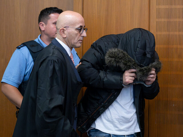 Verdict in torture trial against Syrian doctor 16 June 2025, Hesse, Frankfurt/Main: The accused Syrian doctor (r) is led into the courtro