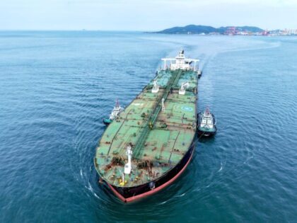 An oil tanker carrying imported crude oil, assisted by a tugboat, heads for Qingdao Port i