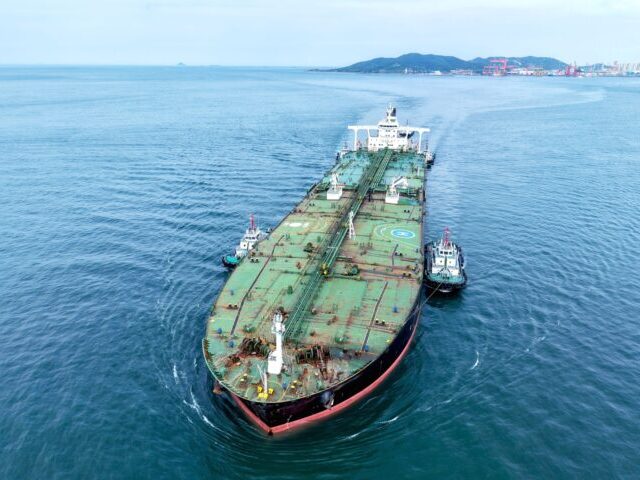 An oil tanker carrying imported crude oil, assisted by a tugboat, heads for Qingdao Port i