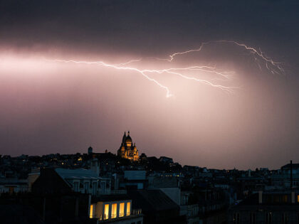 A lighting bolt lights up the sky over Sacre Coeur Basilica in Montmartre during a thunder