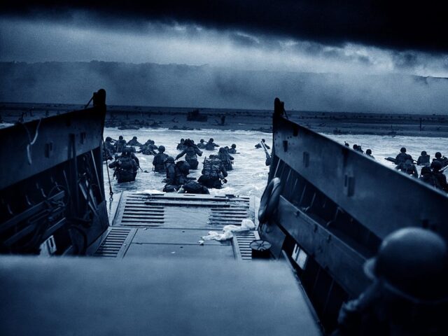Photograph of US Troops rushing to the Normandy Beaches in France during the D-Day landing