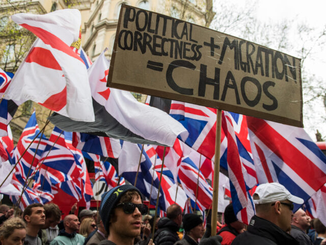 LONDON, ENGLAND - APRIL 01: Protesters hold placards and British Union Jack flags during a