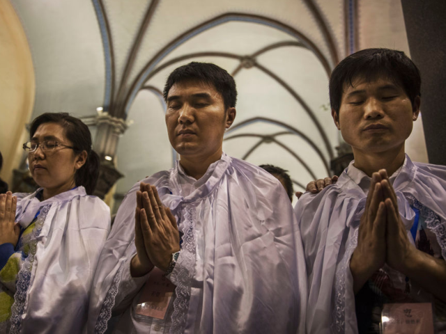 GettyImages-669033656 BEIJING, CHINA - APRIL 15: Newly baptized Chinese Catholic worshippers pray during a speci
