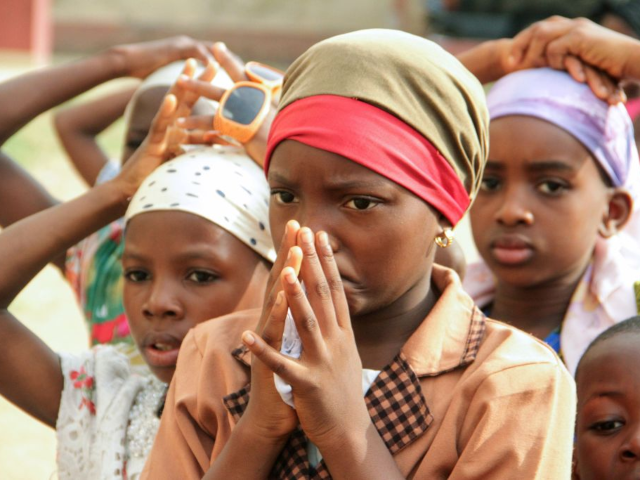 GettyImages-952713856 Children pray during as Christian community members take part in a protest against the kil