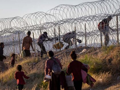 Immigrants cross into the United States from Mexico hoping to be processed by U.S. border