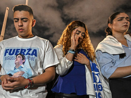 People pray for the health of the Colombian presidential candidate Miguel Uribe outside th