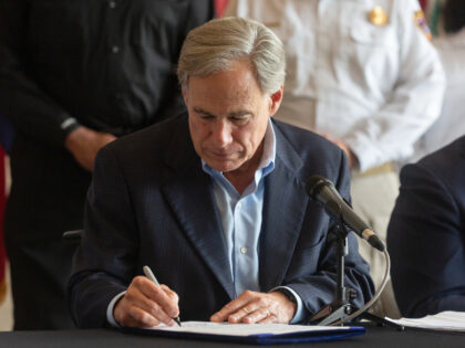 Greg Abbott, governor of Texas, signs a disaster declaration during a news conference in D