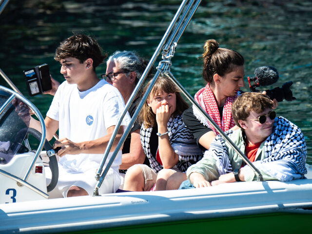 Climate activist Greta Thunberg, center, waits to board the Madleen boat, before setting s