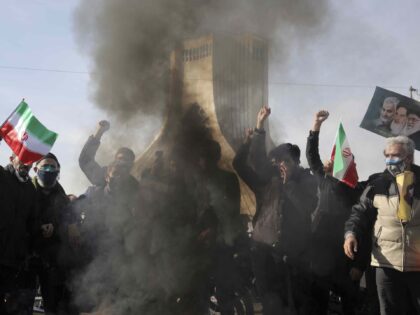 People burn a U.S. flag during a rally at Azadi (Freedom) Square celebrating the 42nd anni