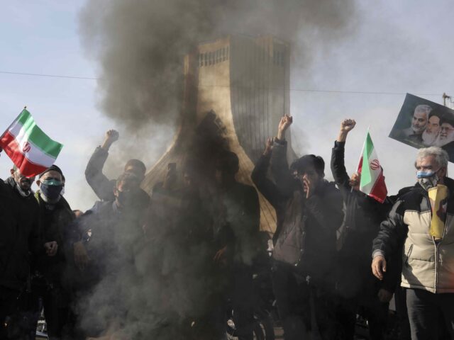 People burn a U.S. flag during a rally at Azadi (Freedom) Square celebrating the 42nd anni
