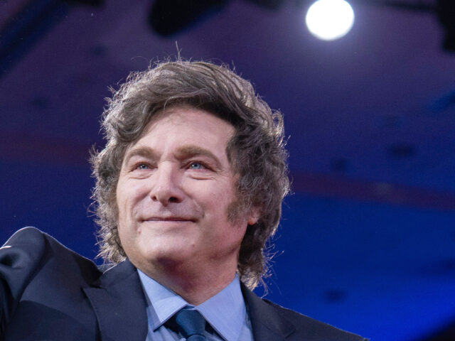 Argentina's President Javier Milei waves to the crowd before speaking at the Conserva