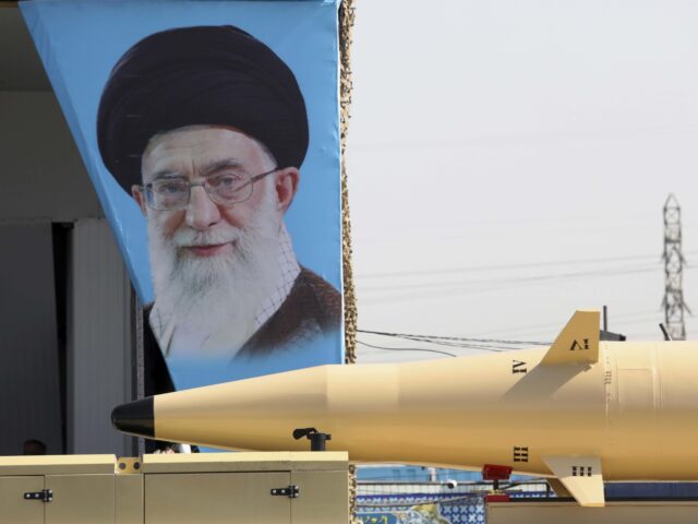 Khamenei missile Iran (Vahid Salemi / Associated Press) A" Khaibar-buster" missile is carried past a portrait of Iranian Supreme Leader