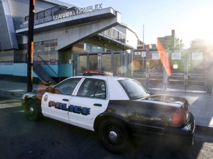 FILE - In this Dec. 15, 2015, file photo, a police car is parked outside of Miguel Contrer