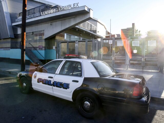 FILE - In this Dec. 15, 2015, file photo, a police car is parked outside of Miguel Contrer
