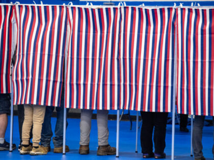 People fill out their ballots in voting booths at the Green Street Community Center in Con