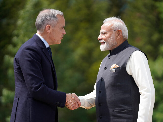 (L/R) Canadian Prime Minister Mark Carney greets Indian Prime Minister Narendra Modi befor