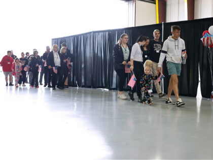 DULLES, VIRGINIA - MAY 12: Newly arrived South Africans wait to hear welcome statements fr