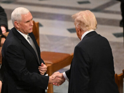 Former US Vice President Mike Pence (L) shakes hands with President-elect Donald Trump bef