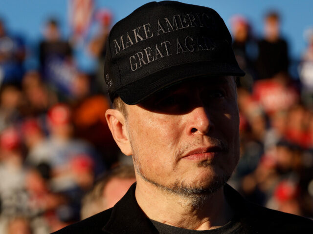 Musk in MAGA Hat Elon Musk wears a black "Make America Great Again" ball cap while attending a ca