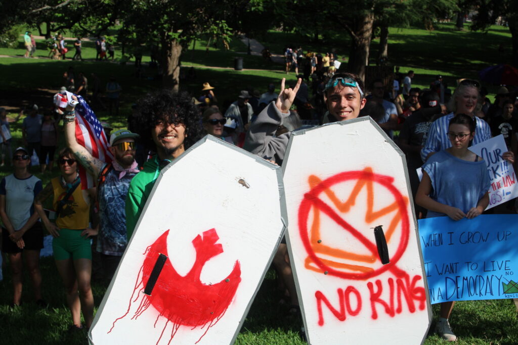 Protesters carry wooden shields in the protest of the Democratic king (Randy Clark/Breitbart Texas)