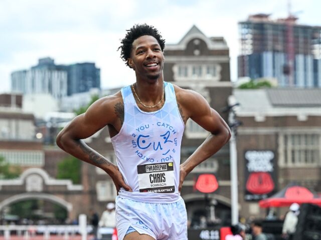 Chris Robinson of the United States stands at the finish line after competing in the Men&#