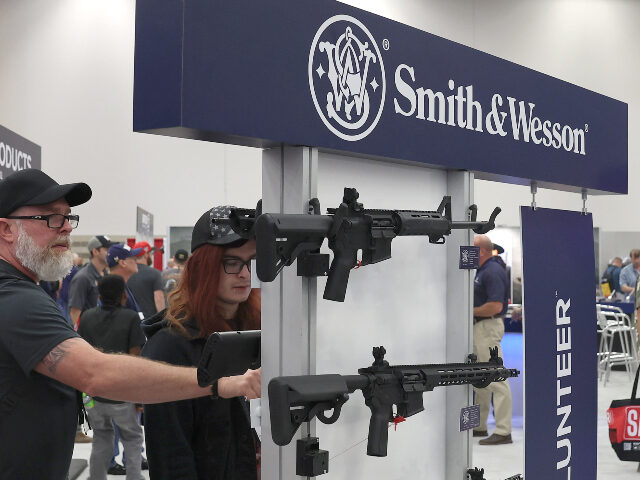 Attendees visit the Smith & Wesson booth during the National Rifle Association (NRA) A