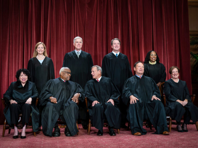 Members of the Supreme Court sit for a group photo following the recent addition of Associ