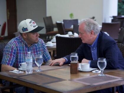 In this photo released by Senator Van Hollen's press office, Hollen, right, speaks wi