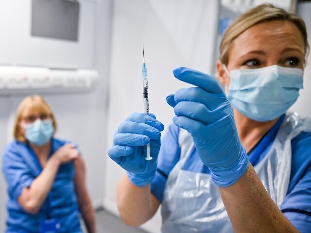 GLASGOW, SCOTLAND - DECEMBER 08: Grace Thomson receives the coronavirus vaccine from Paula