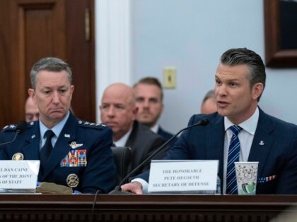 Department of Defense Secretary Pete Hegseth, right, accompanied by Chairman of the Joint
