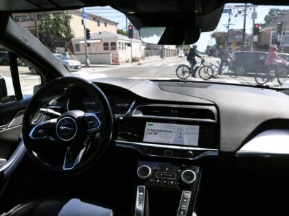 LOS ANGELES, CALIFORNIA - MARCH 14: A Waymo autonomous self-driving Jaguar taxi drives alo