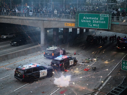 EDS NOTE: OBSCENITY A flash bomb explodes on the 101 Freeway near the metropolitan detenti