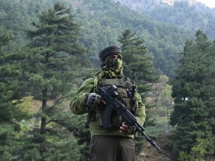 An Indian paramilitary serviceman keeps watch in Pahalgam, south of Srinagar on April 23,