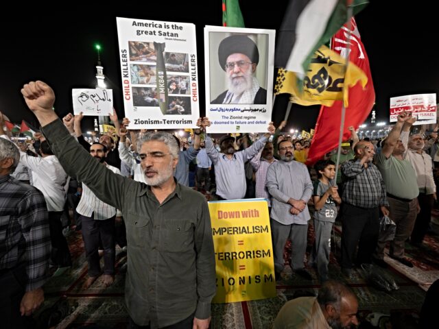 Iranian protesters shout anti-U.S. and anti-Israeli slogans while some of them hold placar