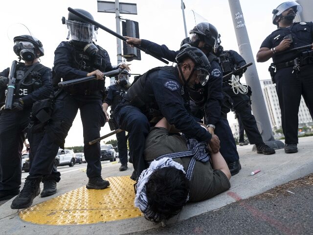 LOS ANGELES, CALIFORNIA - JUNE 06: LAPD officers arrest a protester outside of the Federal
