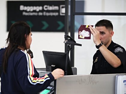 MIAMI, FL - FEBRUARY 27: A U.S. Customs and Border Protection officer uses facial recognit
