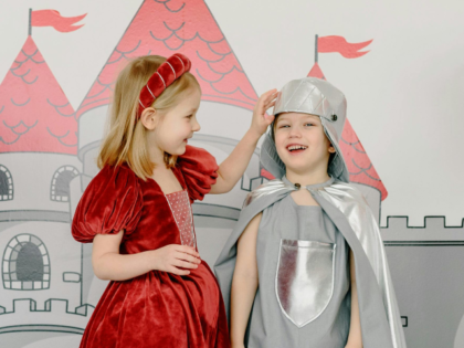 Children in Costumes Standing Beside a Castle Wall Painting