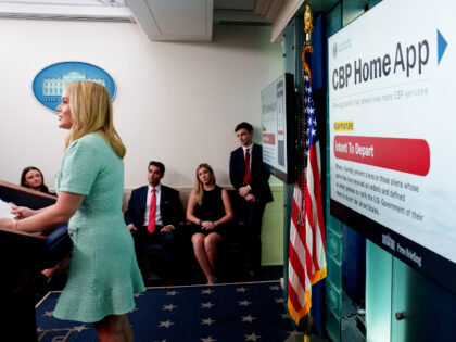 A monitor displays a new U.S. Customs and Border Protection app with "a self-deportat