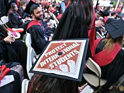 CAMBRIDGE, MA - MAY 29: A Harvard University graduate with a message in support of interna