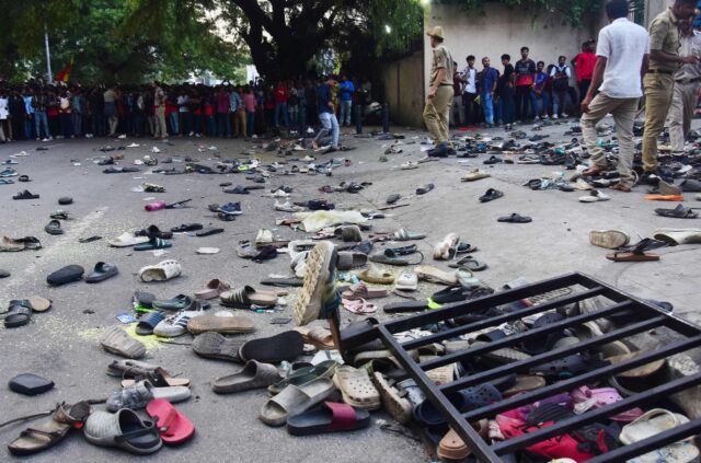 Abandoned shoes and a fallen barrier outside the Chinnaswamy Stadium in Bengaluru after a