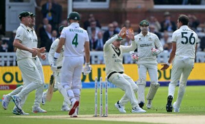Australia's Mitchell Starc celebrates with Steve Smith (C) after dismissing South Africa's