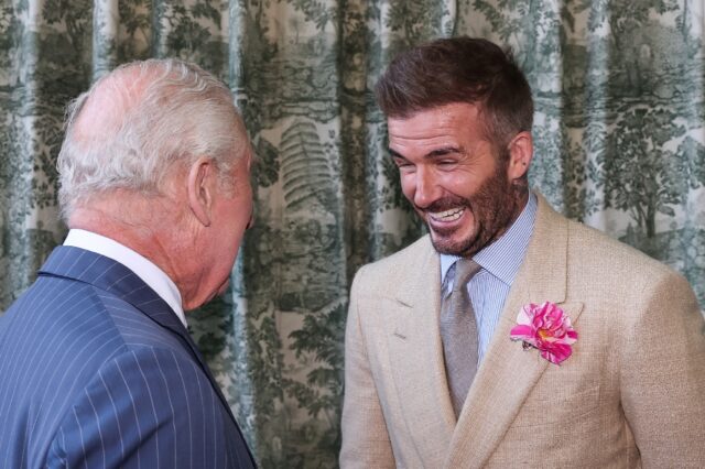 Britain's King Charles III speaks with former England captain David Beckham at the Chelsea