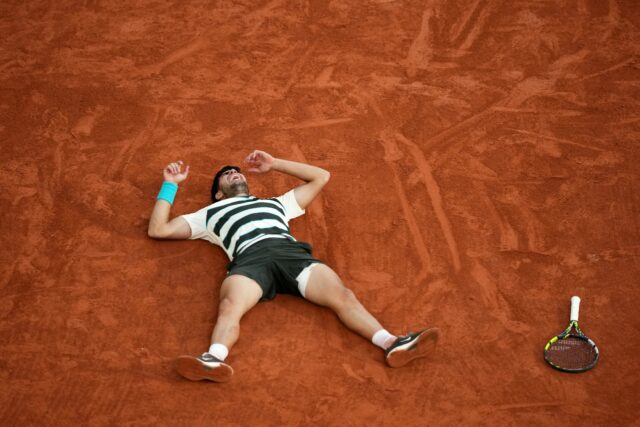 Carlos Alcaraz celebrates after an incredible French Open win over Jannik Sinner in five s