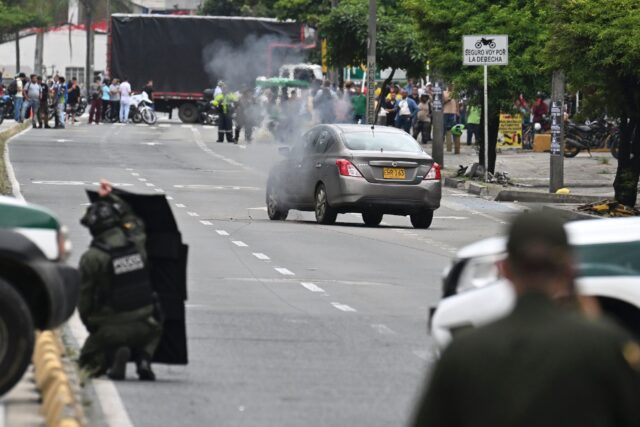 Colombian anti-explosives policemen carry out a controlled detonation during a search for