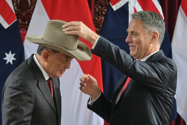 Indonesia's Defence Minister Sjafrie Sjamsoeddin received a hat from his Australian counte